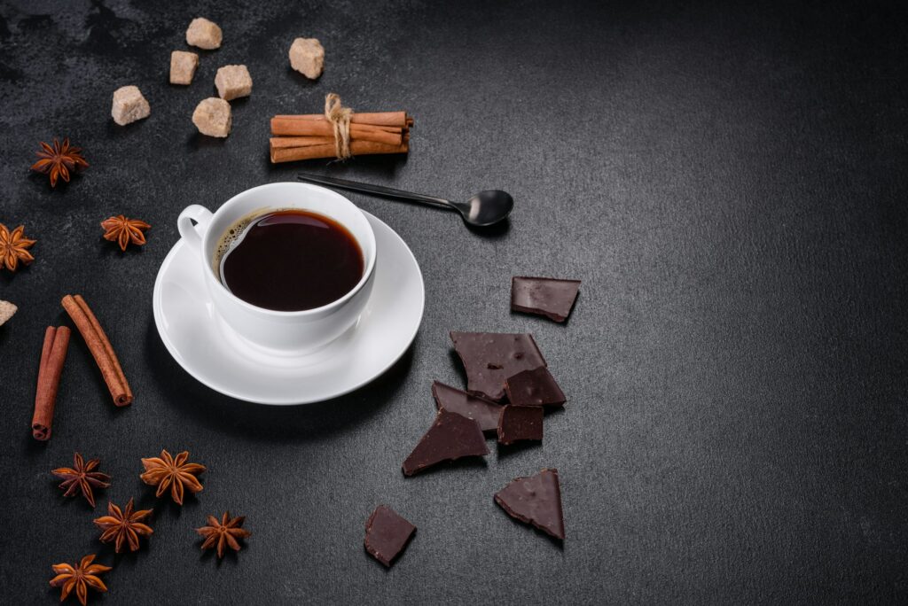 Broken black chocolate pieces with star anise and cinnamon