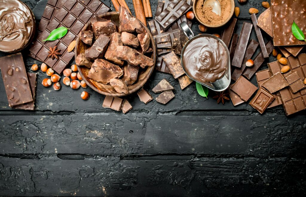 Chocolate background. Various assortment of chocolate with paste.